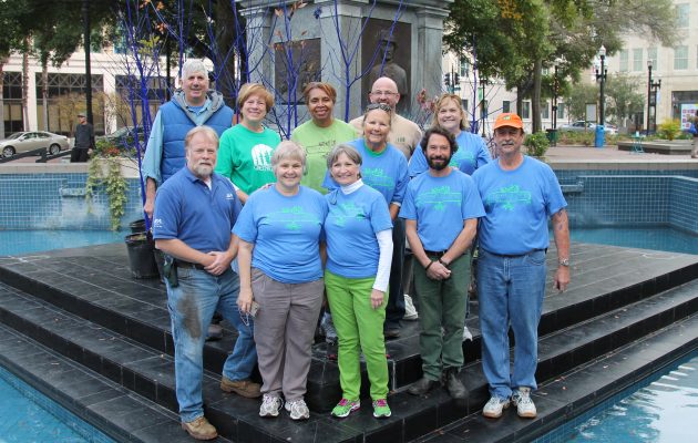 Residents paint trees blue for art and awareness