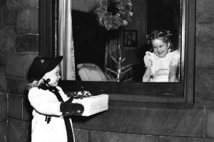 Blair Jones’ cousin, Louise Lewis, offers her a gift in a photo staged for a holiday ad in a local newspaper in Richmond, Virginia.
