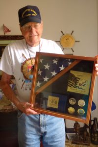 Marvin Hollis with World War II memorabilia