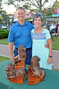 Lions’ statute architects Angela Schifanella and her husband, Alan Wilson, stand with a bronze model donated by T. Wayne Davis. Schifanella and Wilson designed the San Marco landmark 21 years ago.
