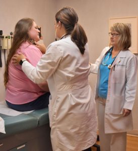 Medical staff at Volunteers in Medicine see a patient at the downtown clinic.