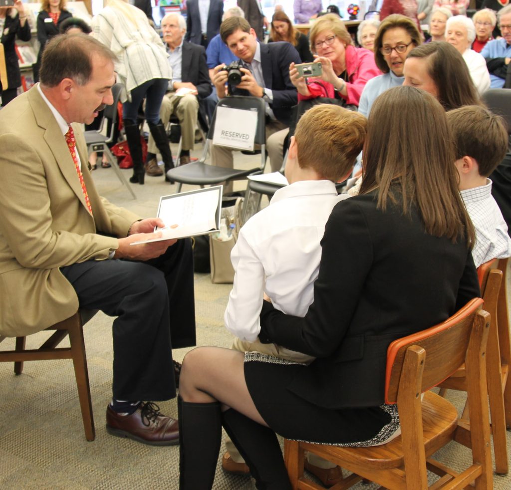 Councilman John Crescimbeni reads his book, “Bill Brinton – Library Hero” to Brinton’s three grandchildren.