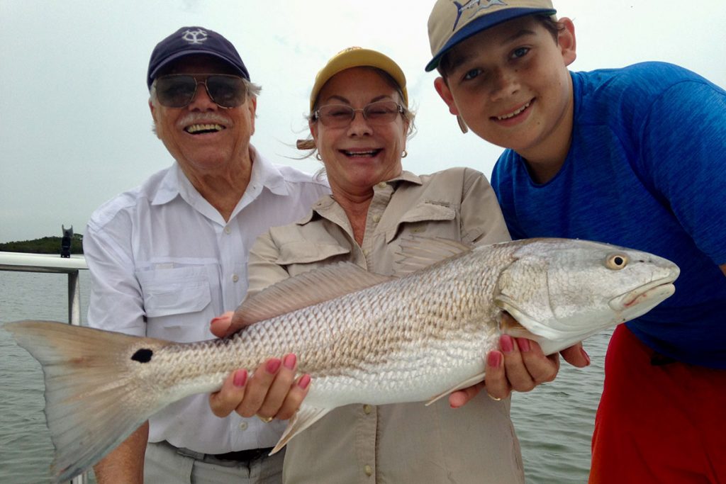 H.L. and Phyllis Lockwood Geiger and grandson, Daniell Lockwood Behringer, fishing last summer in Tampa Bay with Capt. Joel Brandenburg.