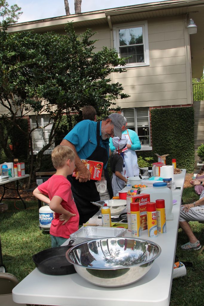 The Holy Trinity Anglican Church Men's Club stirs up batter for the pancake brunch at the Easter Eggstravaganza April 13.