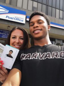 Amy Donofrio with Alan McCullough, showing off his new passport for a trip to Brazil for a speaking engagement.