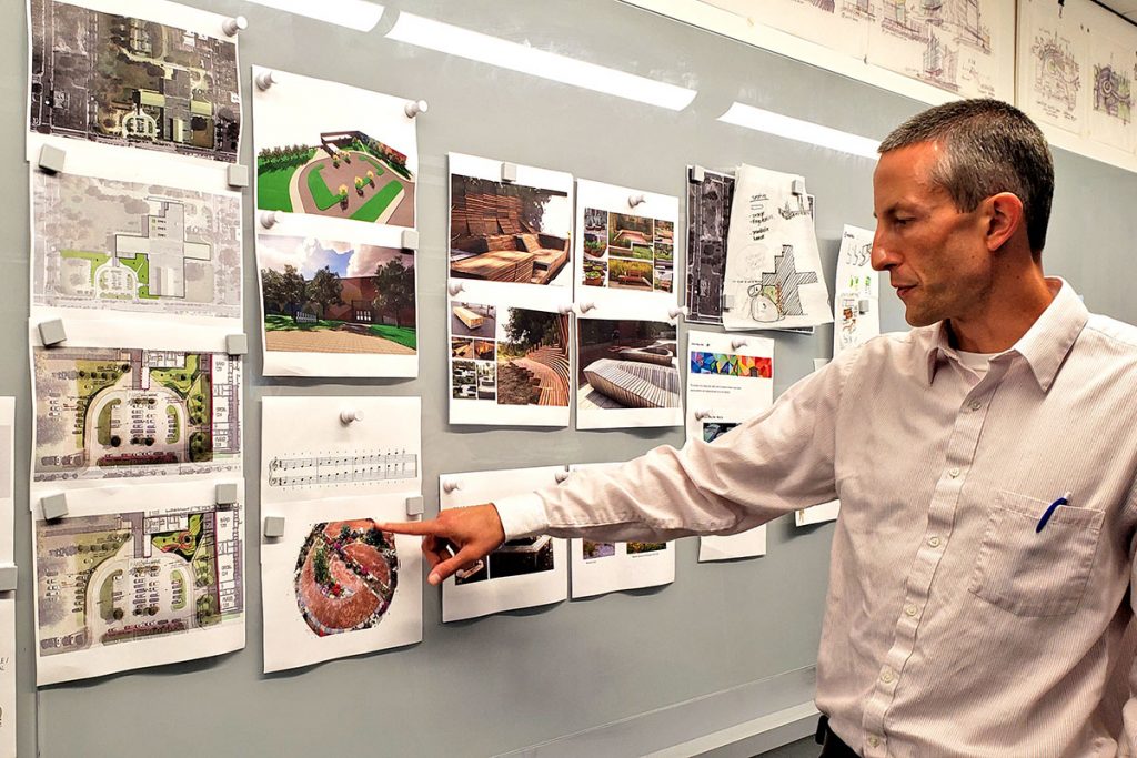 Jacob Thurlow points to a landscaping idea that summer interns considered for the landscaping project at LaVilla School of the Arts.