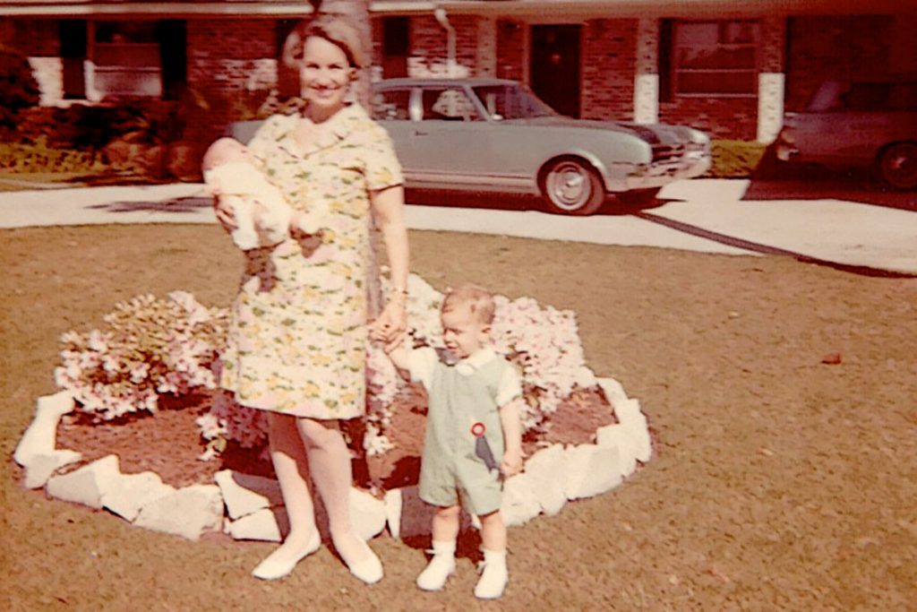 Katherine Monahan with Mark as babe-in-arms holds onto Jim in front of their Ortega Forest home on Waverly Lane.