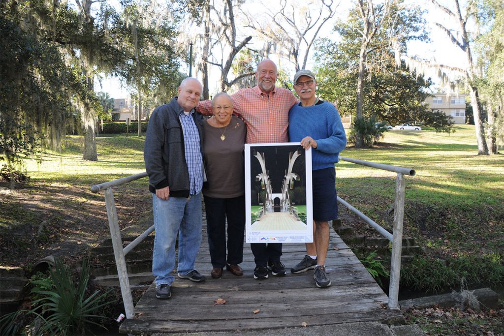 AIDS Memorial Project of Northeast Florida board members Joe Caliandro, Frieda Saraga, Wally Ericks and Richard Ceriello hold up a representation of how they would like the bridge they are standing on to be transformed.