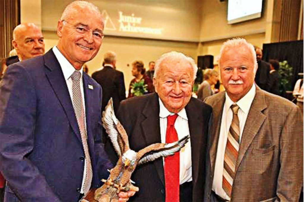 Harry Frisch, and his sons, Ben and Karl Frisch, when Frisch received the Junior Achievement award