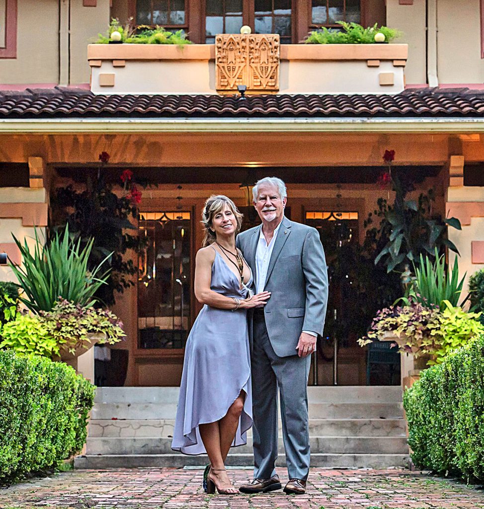 Lana Shuttleworth Wood and Wayne Wood in front of their historic home, built in 1913.