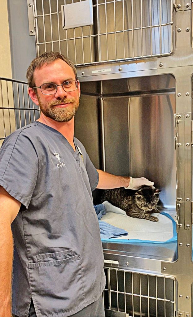 Jacksonville Humane Society Chief Medical Officer Dr. Stan Hill giving some extra attention to Scooter, who is recovering from a skin condition and will soon be ready for adoption.
