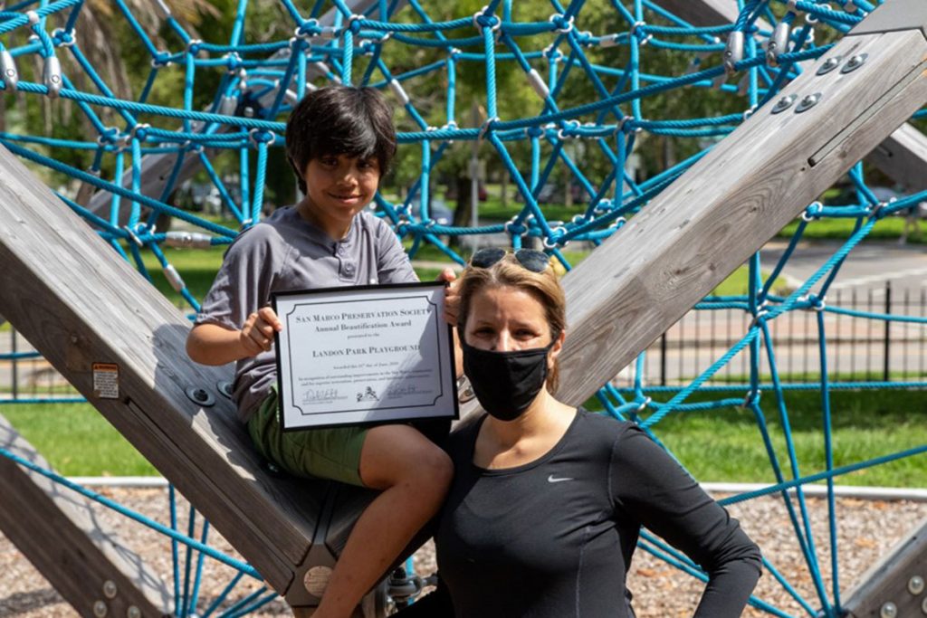 Jake Cumber and his mother, District 5 City Councilwoman LeAnna Cumber accept the SMPS Beautification Award on behalf of the City of Jacksonville for improvements to Landon Park Playground.