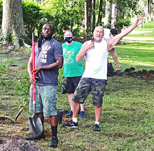 James Cook, Randy Lawson and Wally Ericks assist in planting a garden in Willowbranch Park.