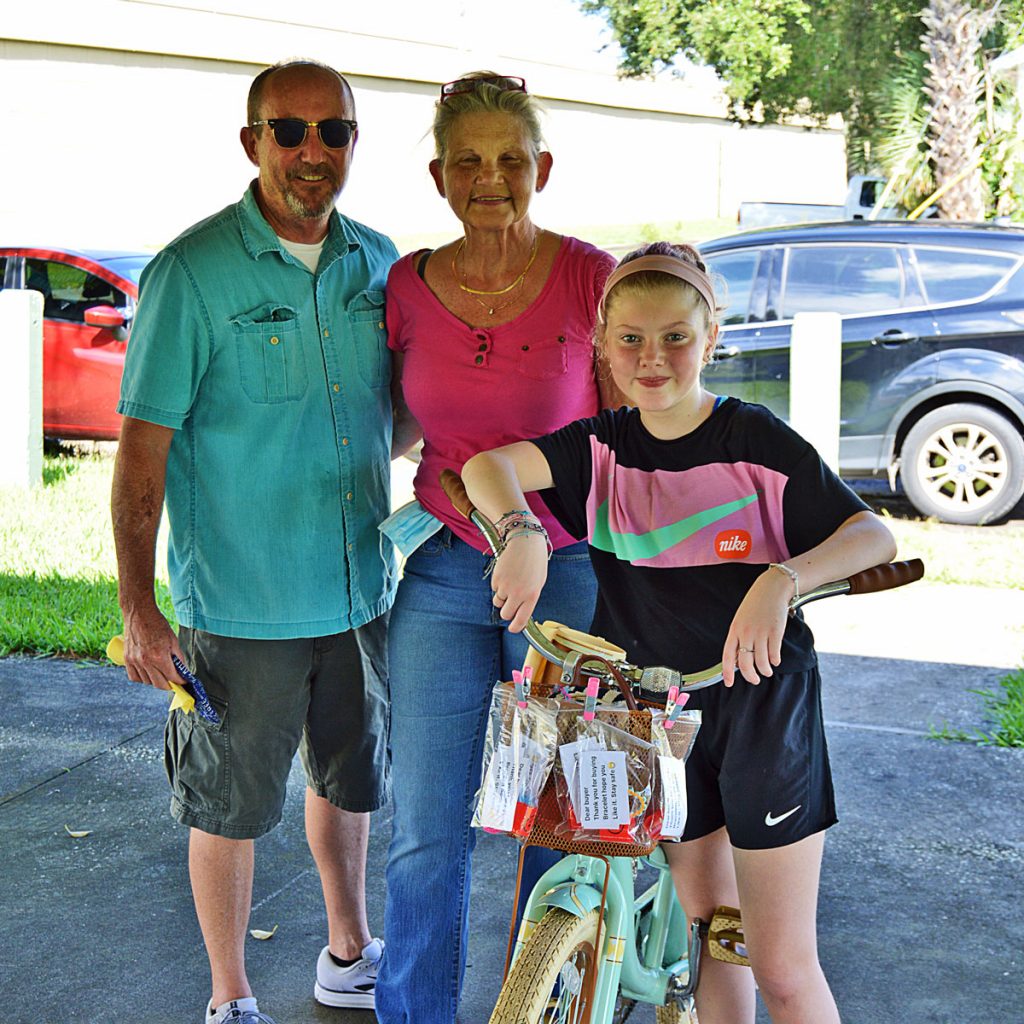 Mackenzie Meyer with her walking buddies, Bobby and Pam Back