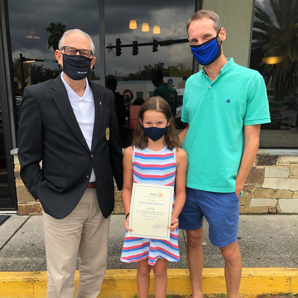 San Marco Rotary Club President Pete Helow with Lucy Page and her father, Tim