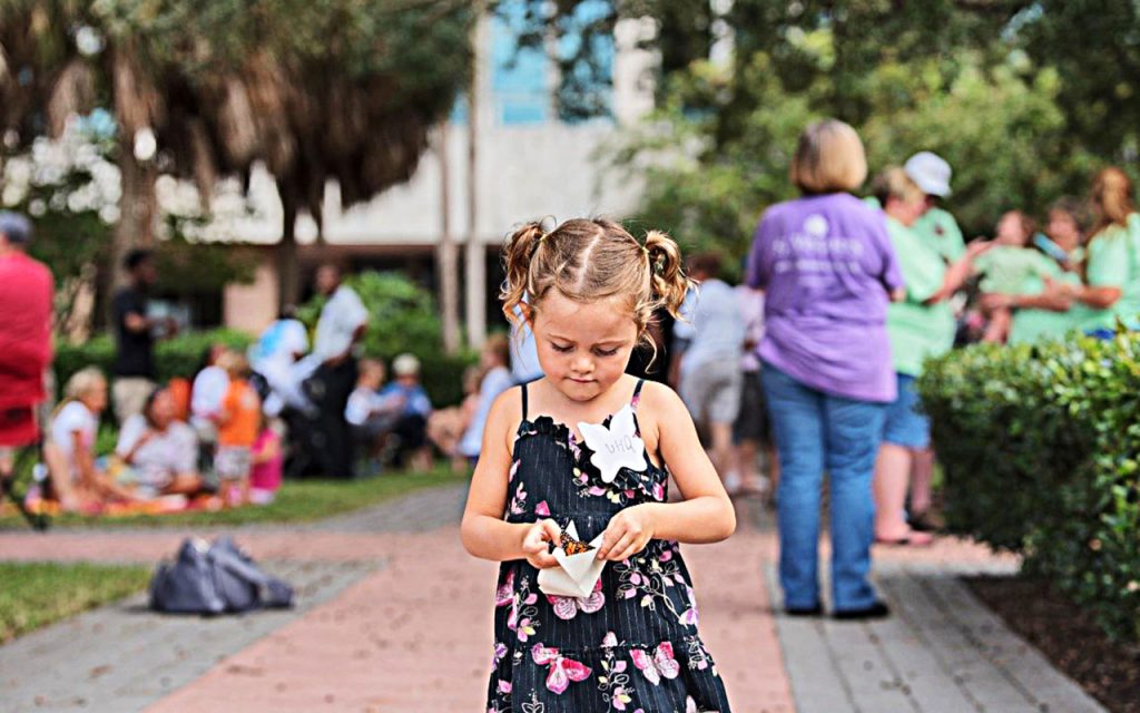 A sibling releases a butterfly