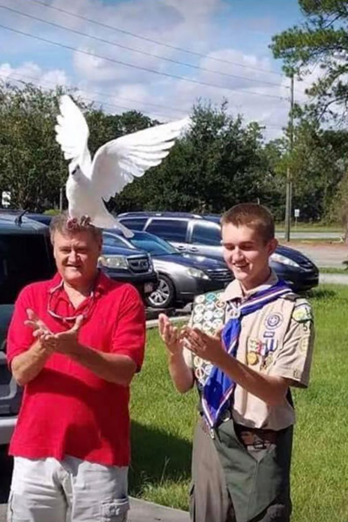 John Glisson overcame autism to earn the rank of Eagle Scout and is pictured with his father, George Glisson at a white dove release ceremony held in his honor by his family.