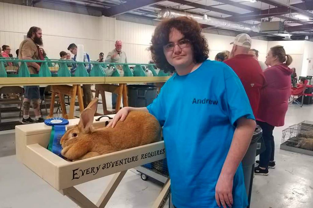 Andrew Hettick with Rene, his Flemish Giant, Blue Ribbon Winner for Best in Breed