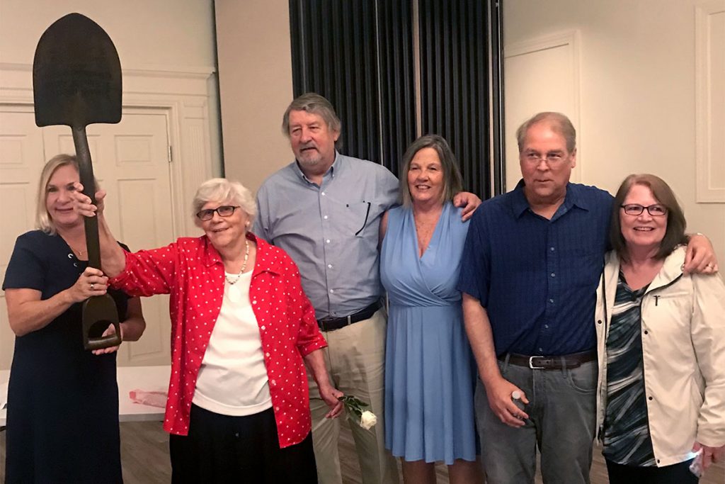 Adrienne Hollis, St. Elmo Acosta’s oldest living granddaughter, brought the shovel that Acosta used in the groundbreaking for the bridge. Also shown are Andy Acosta Newman, Acosta’s youngest living granddaughter, to the left of Adrienne Hollis, and Curt and Debbie Hollis with Doug and Linda Hollis.  
