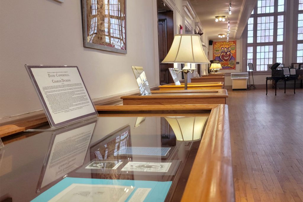 Rows of podiums showcase folios from various 19th century British writers, including Sir Arthur Conan Doyle and Charles Dickens. Photo by Michele Leivas.