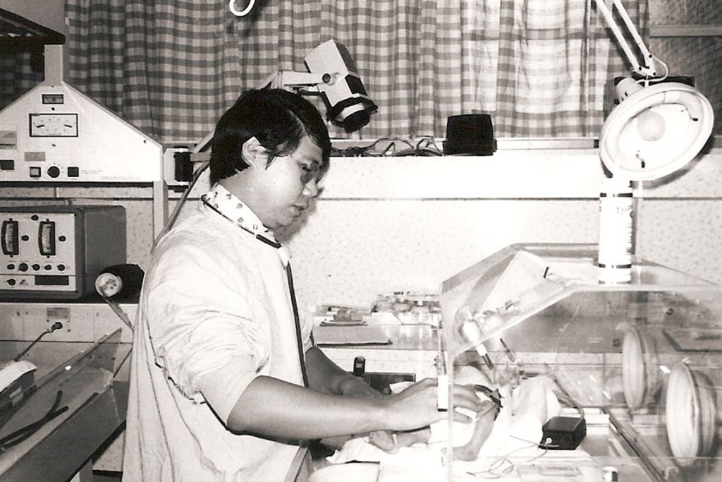 Dr. Thomas Chiu tends to a newborn in the NICU in the 1970s.