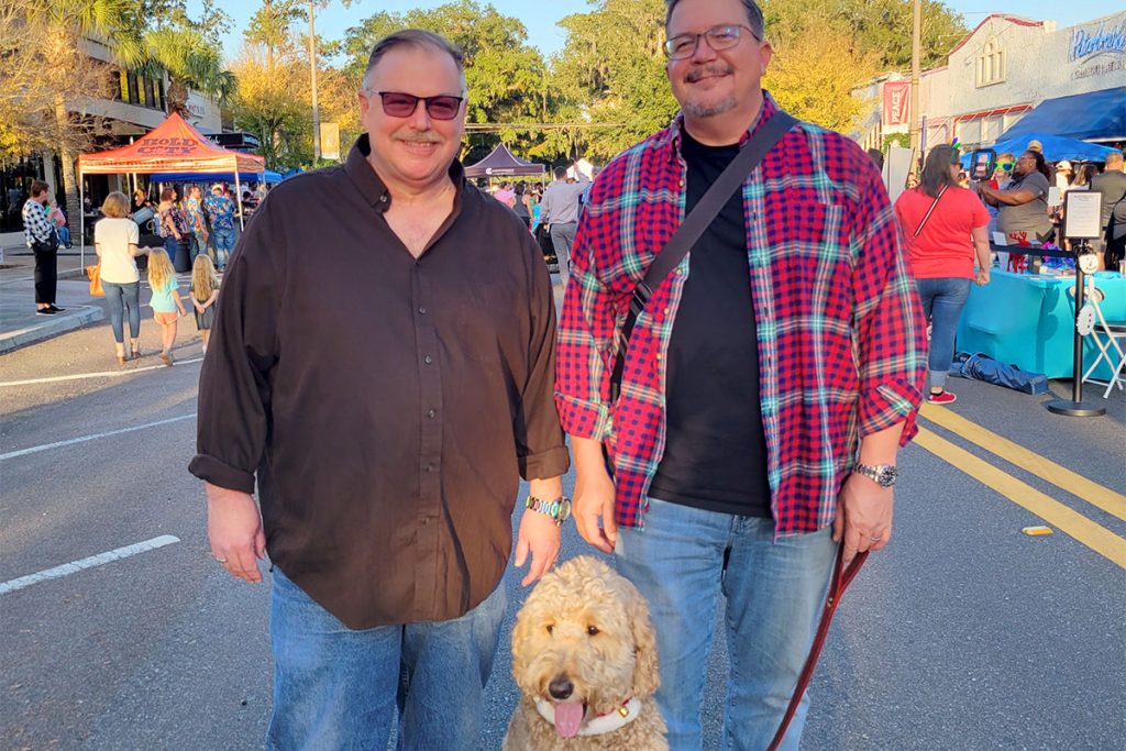 David Cash, Jeff Wright and their furry friend Beau, who got in the holiday spirit with some festive collar accessories.