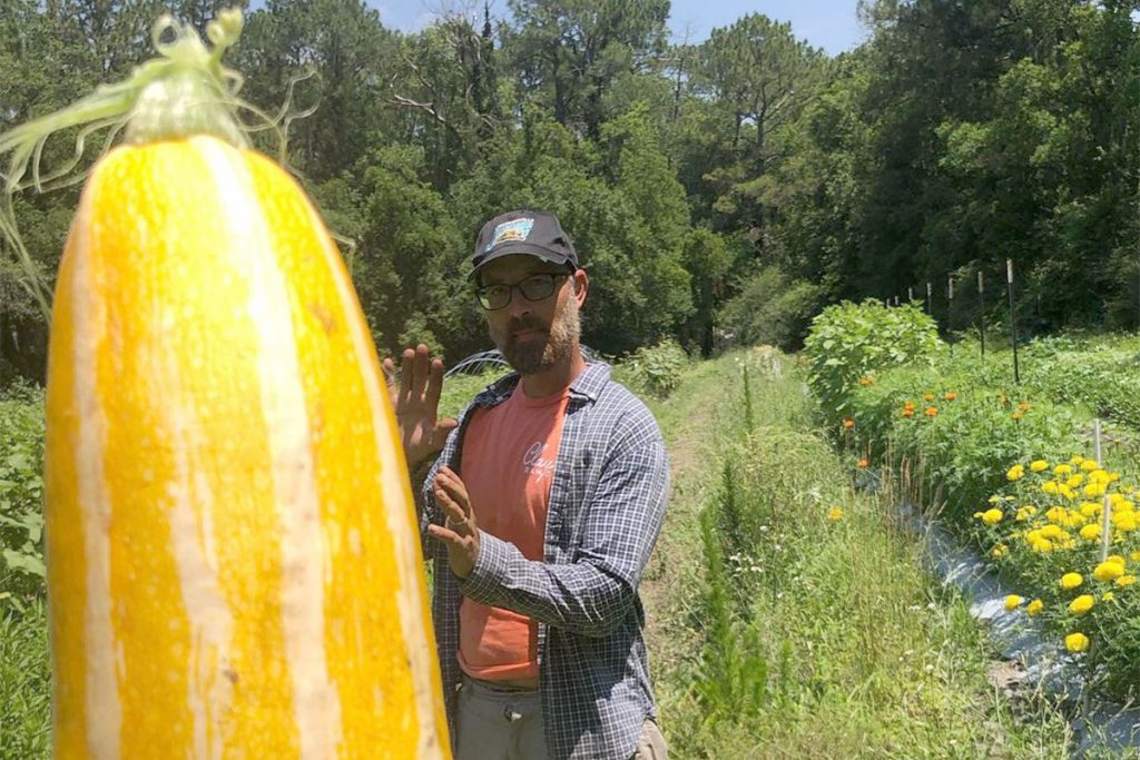 Brian and a Down to Earth zucchini | Picture Credit - Down to Earth Farm