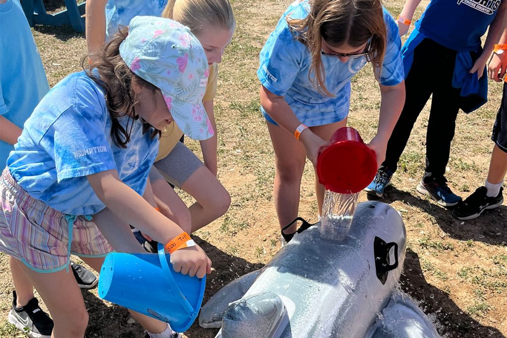 Marian Darling, Stella Fullerton and Allie Kling perform a dolphin “rescue.”