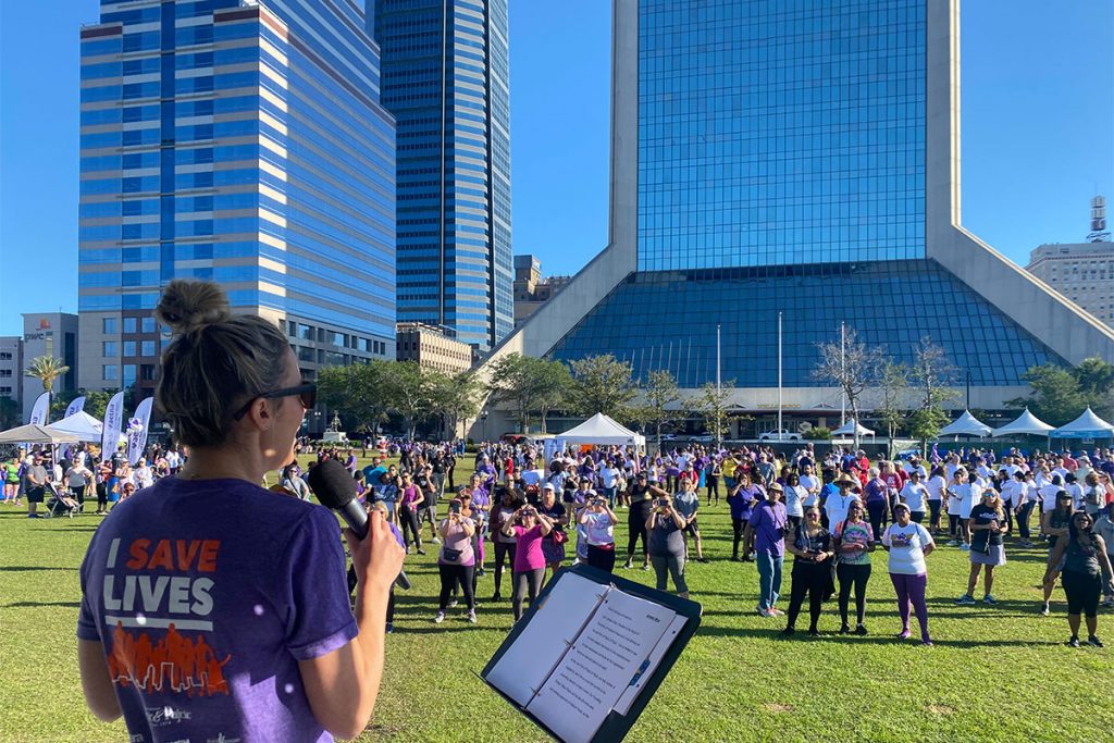 woman speaking in microphone to crowd