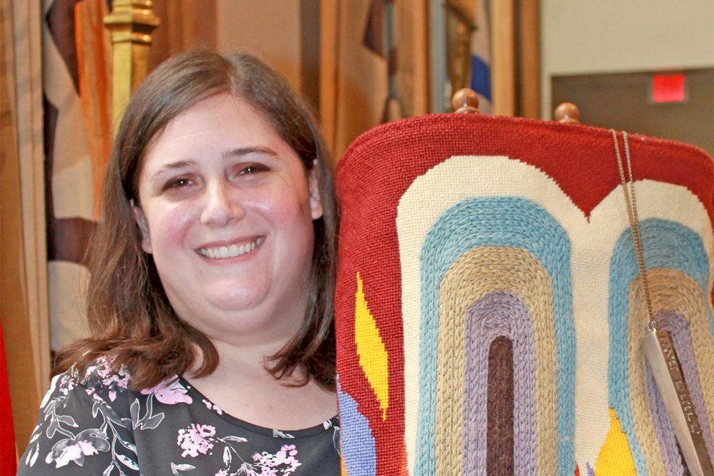 Rabbi Maya Glasser holds the Torah.