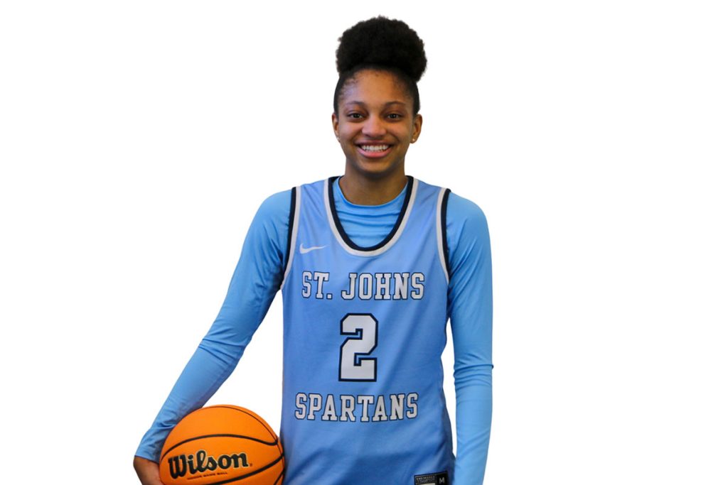 Taliah Scott smiling while holding basketball