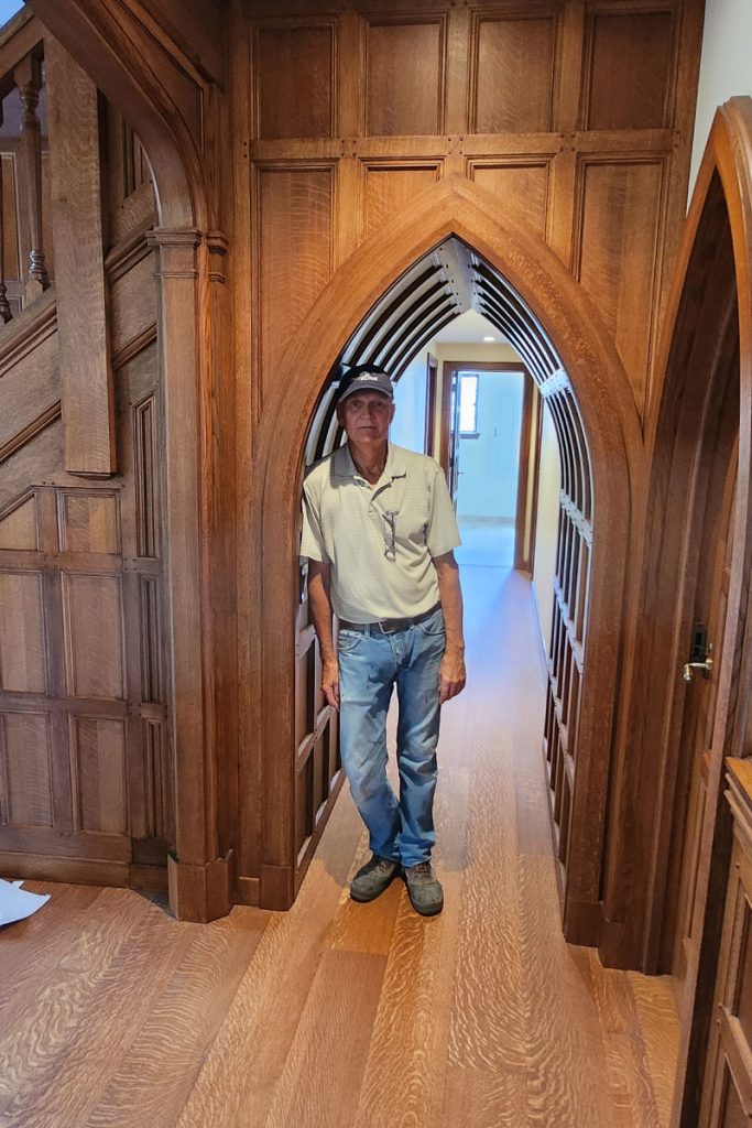 man standing under arched hall