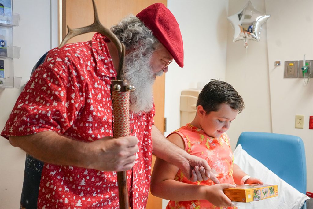 Santa and boy looking at gift