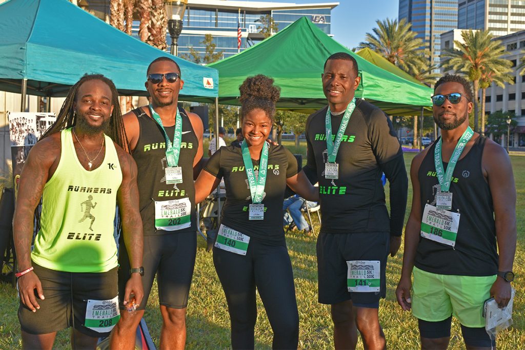 smiling people with Emerald Trail 5K gear on