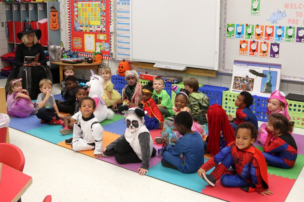 Nancy Beecher reads to costumed Upson students.