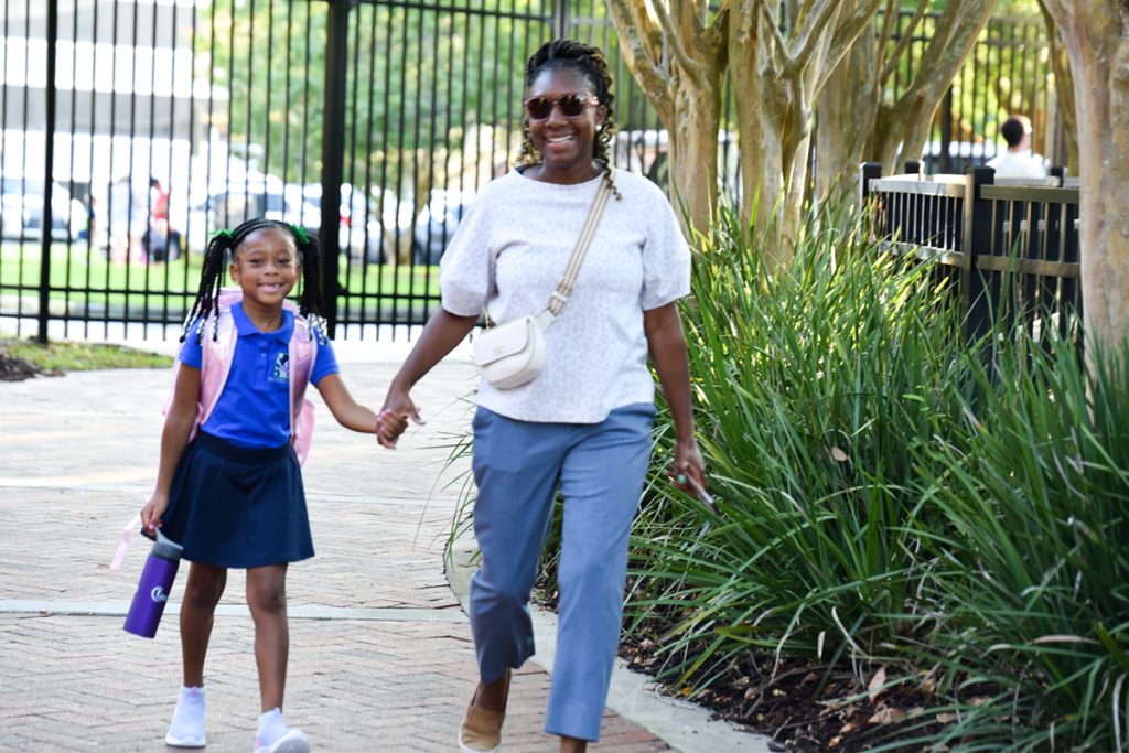 smiling woman and girl walking