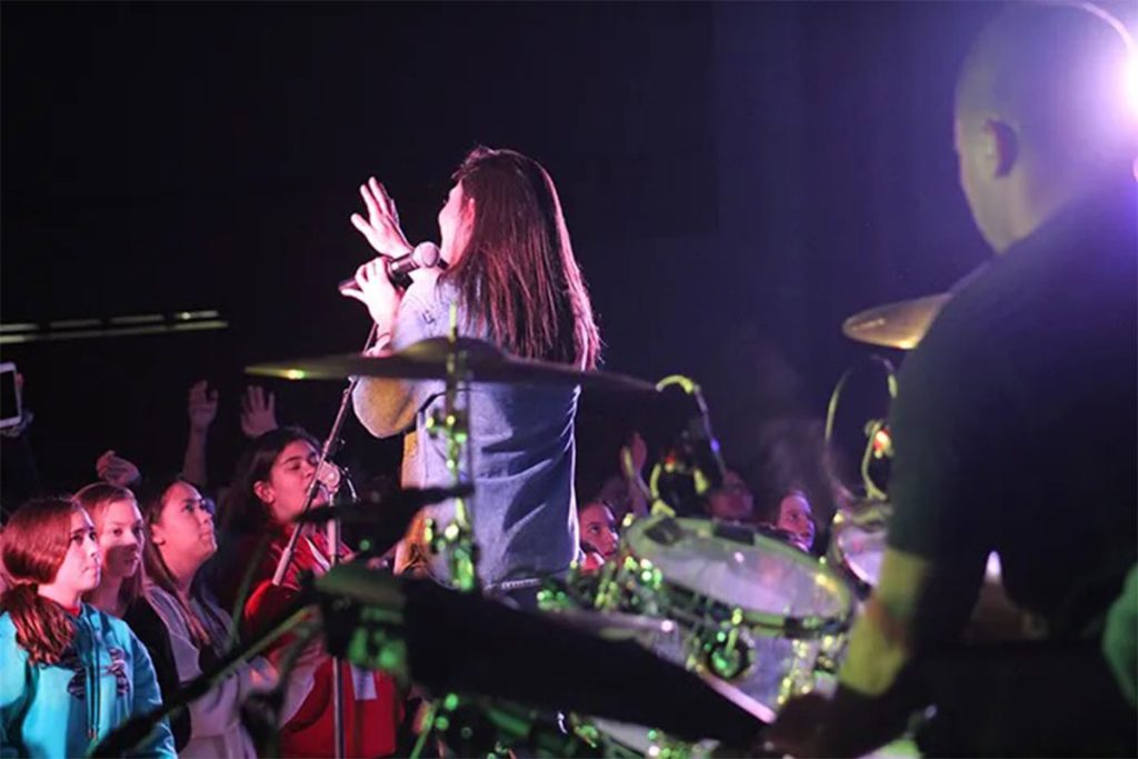 female singing to crowd