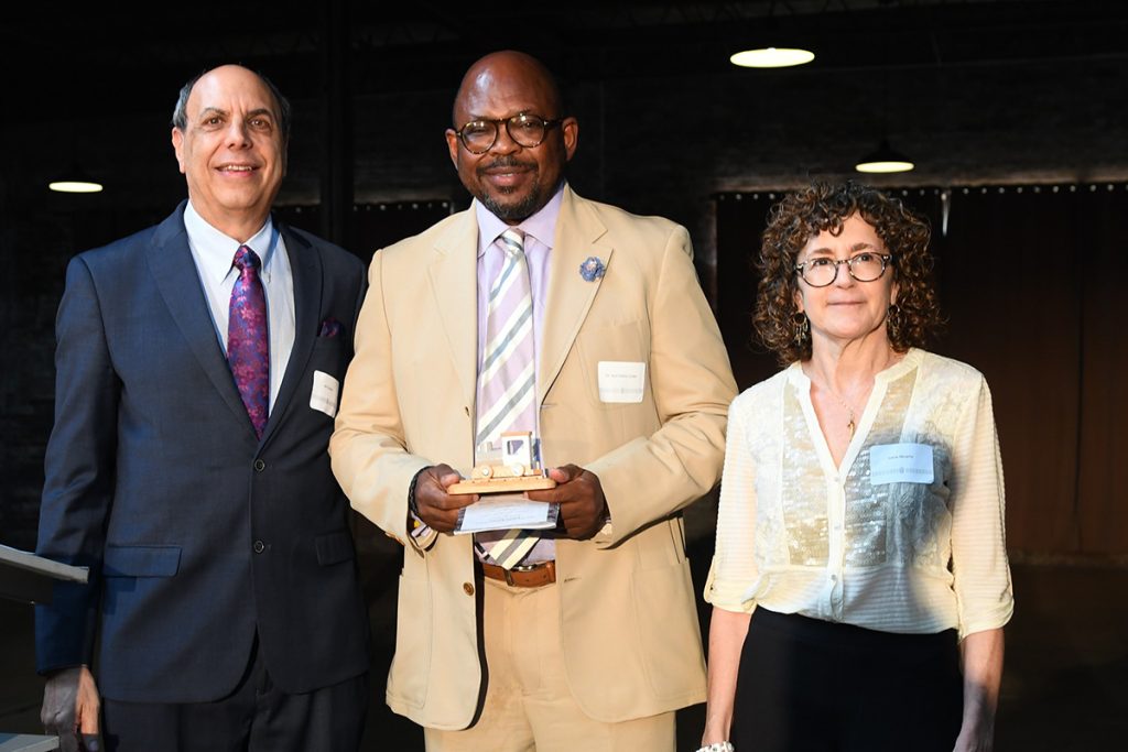 Jeff Edwards and Annie Murphy of the Rail Yard Business District Council present LISC Jacksonville Executive Director Dr. Irvin PeDro Cohen with the council’s inaugural All Aboard Award.