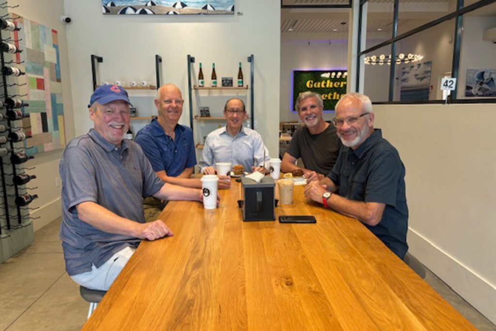 the group of men sitting at coffee table