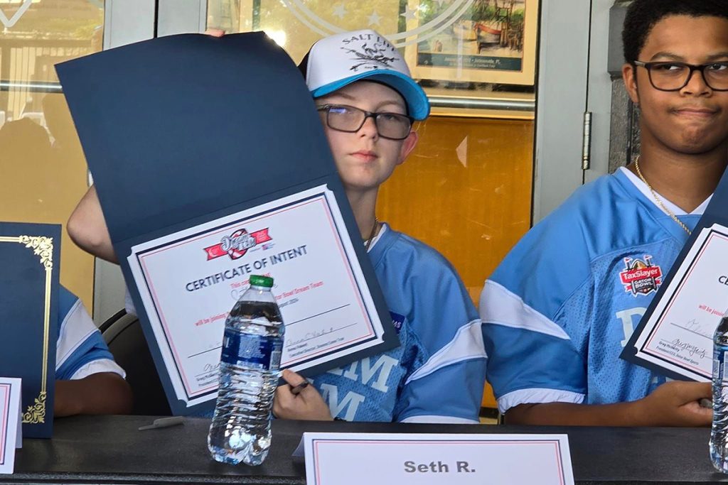 Dream Team member Seth Rowe displays his Signing Day certificate.