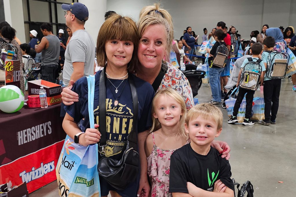 Kimberly Anderson poses with her grandchildren Boston, Ireland and London at the Pack the Sack II event.