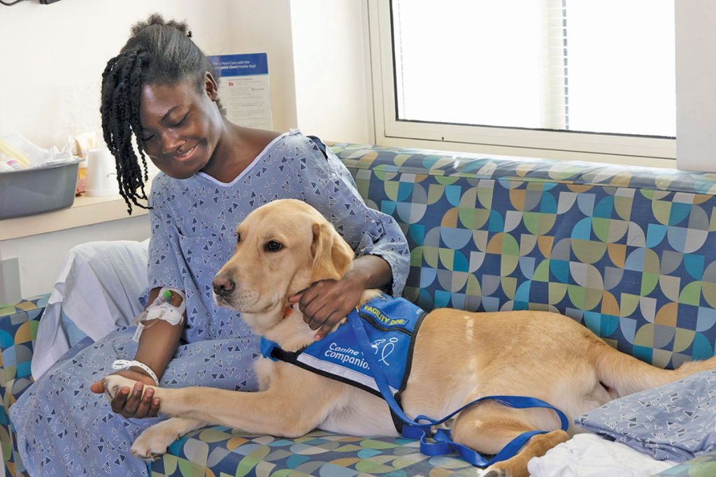 Jude with a patient (sitting on couch)